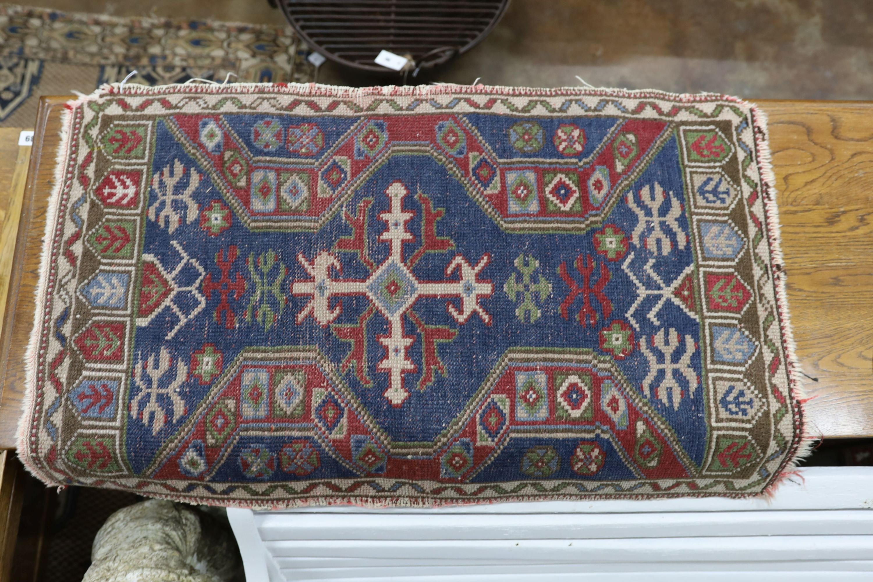 Four Caucasian and North West Persian mats, largest 87 x 88cm